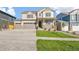 Inviting two-story home with a three car garage, covered porch, and manicured lawn at 13486 Valentia St, Thornton, CO 80602