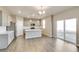 Open concept kitchen with stainless appliances, a center island and a sliding glass door at 13486 Valentia St, Thornton, CO 80602