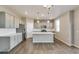 Bright kitchen with stainless steel appliances, gray cabinets, an island, and modern pendant lighting at 13486 Valentia St, Thornton, CO 80602
