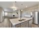 Spacious kitchen with stainless steel appliances and center island sink overlooks the adjacent living space at 13486 Valentia St, Thornton, CO 80602