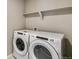Laundry room showcasing a Whirlpool washer and dryer at 13486 Valentia St, Thornton, CO 80602