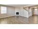 Bright living room with hard wood floors, and fireplace with white tile surround at 13486 Valentia St, Thornton, CO 80602