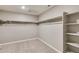 Spacious walk-in closet with carpeted floor, shelving and clothes bars at 13486 Valentia St, Thornton, CO 80602
