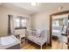 Bedroom with white crib and hardwood floors visible from a bedroom doorway at 3280 Fenton St, Wheat Ridge, CO 80212