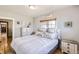 Comfortable bedroom with stylish furniture, a decorative bed, and hardwood floors at 3280 Fenton St, Wheat Ridge, CO 80212