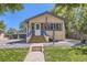 Charming home with inviting staircase and gravel landscaping under a clear sky at 3280 Fenton St, Wheat Ridge, CO 80212