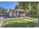 Charming home with a well-manicured lawn, complemented by blue trim and natural accents at 3280 Fenton St, Wheat Ridge, CO 80212