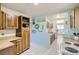 Charming kitchen with wooden cabinets, tile floors, and a pass-through to another room at 3280 Fenton St, Wheat Ridge, CO 80212