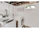 Finished basement laundry room with modern appliances, clean white walls, and a decorative 'Loads of Fun' sign at 3280 Fenton St, Wheat Ridge, CO 80212