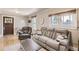 Inviting living room with a gray sofa and natural light streaming through the windows at 3280 Fenton St, Wheat Ridge, CO 80212