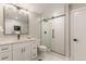 Bathroom featuring a glass shower enclosure, a modern vanity with black hardware, and a neutral color palette at 2552 E Alameda Ave # 92, Denver, CO 80209