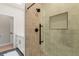 Shower with modern fixtures, geometric tile surround, and integrated toiletry niche at 2552 E Alameda Ave # 92, Denver, CO 80209