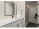 Modern bathroom featuring a glass shower, white vanity, and stylish black fixtures at 2552 E Alameda Ave # 92, Denver, CO 80209