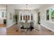 Elegant dining room with a glass table, stylish chairs, and a large bay window providing ample natural light at 2552 E Alameda Ave # 92, Denver, CO 80209