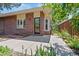 Home exterior featuring a brick facade, bay windows, and patio with a fountain feature at 2552 E Alameda Ave # 92, Denver, CO 80209