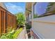 Home exterior featuring lush landscaping with wood fence on a sunny day at 2552 E Alameda Ave # 92, Denver, CO 80209