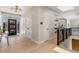 Entryway with modern light fixture, wood floors, and open layout to the staircase and dining area at 2552 E Alameda Ave # 92, Denver, CO 80209