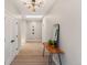 Bright hallway with skylight, modern light fixture, wood floors, and stylish console table at 2552 E Alameda Ave # 92, Denver, CO 80209