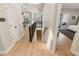 Open floor plan with hardwood floors leading to a bedroom, kitchen, and staircase to basement at 2552 E Alameda Ave # 92, Denver, CO 80209