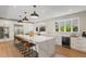 Bright kitchen with a large island, stainless steel appliances, pendant lighting, and ample counter space at 2552 E Alameda Ave # 92, Denver, CO 80209