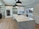 Bright kitchen features an oversized island, stainless appliances, and modern white cabinetry at 2552 E Alameda Ave # 92, Denver, CO 80209
