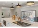 Well-appointed kitchen island featuring a cooktop and seamless access to outdoor living space via sliding glass doors at 2552 E Alameda Ave # 92, Denver, CO 80209