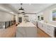 Open kitchen with a large island, stainless steel appliances, ample storage, and easy access to other living spaces at 2552 E Alameda Ave # 92, Denver, CO 80209