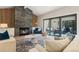 Bright living room featuring a marble fireplace, plush rug and sliders to the outdoor space at 2552 E Alameda Ave # 92, Denver, CO 80209