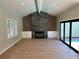 Spacious living room featuring a fireplace, wood floors, large windows, and ample natural light at 2552 E Alameda Ave # 92, Denver, CO 80209