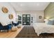 Light-filled main bedroom with outdoor access, and featuring chic decor and wood floors at 2552 E Alameda Ave # 92, Denver, CO 80209