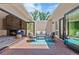 Stylish outdoor patio with brick flooring, modern seating, and bi-fold doors opening to the interior at 2552 E Alameda Ave # 92, Denver, CO 80209