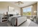Cozy bedroom with neutral walls, window, carpet and a comfortable upholstered bed at 11972 W Long Cir # 104, Littleton, CO 80127
