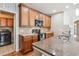 Kitchen featuring granite countertops, stainless steel appliances, and wood floors at 11972 W Long Cir # 104, Littleton, CO 80127