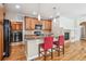 Kitchen with island, bar stool seating, and stainless steel appliances at 11972 W Long Cir # 104, Littleton, CO 80127