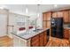 Open kitchen with granite countertops, stainless steel appliances, and hardwood floors at 11972 W Long Cir # 104, Littleton, CO 80127
