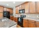 Kitchen featuring a center island with granite countertops and stainless steel appliances at 11972 W Long Cir # 104, Littleton, CO 80127