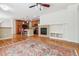 Open concept living room featuring a fireplace, wood floors, and bar stool seating at 11972 W Long Cir # 104, Littleton, CO 80127