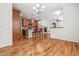 Living room view into kitchen with hardwood floors, ceiling fan, and recessed lighting at 11972 W Long Cir # 104, Littleton, CO 80127