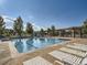 Resort-style pool with lounge chairs offers a perfect spot for relaxation and recreation on a sunny day at 11972 W Long Cir # 104, Littleton, CO 80127