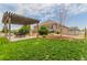 Backyard features a pergola over a dining area with outdoor seating at 10653 E 163Rd Ct, Brighton, CO 80602