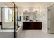 Bright bathroom featuring double sinks, a soaking tub, and a glass enclosed shower at 10653 E 163Rd Ct, Brighton, CO 80602