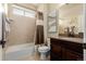 Bathroom features a tiled shower, dark wooden vanity, and neutral color scheme at 10653 E 163Rd Ct, Brighton, CO 80602