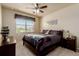 Well-lit bedroom features a bed, large window, and neutral decor with carpeted floors at 10653 E 163Rd Ct, Brighton, CO 80602