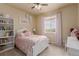 Bright bedroom featuring a white bed frame, pink bedding, and natural light from the window at 10653 E 163Rd Ct, Brighton, CO 80602