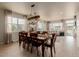 The dining room features a modern light fixture and lots of natural light overlooking the backyard at 10653 E 163Rd Ct, Brighton, CO 80602