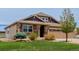 Charming two-story home featuring a well-manicured lawn, tasteful landscaping and a two car garage at 10653 E 163Rd Ct, Brighton, CO 80602