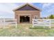 Exterior shot of garage with white fencing, accessible from the front yard at 10653 E 163Rd Ct, Brighton, CO 80602