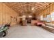 Large garage space with ample storage, workbench, and a cozy seating area at 10653 E 163Rd Ct, Brighton, CO 80602
