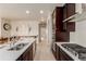 Bright, open kitchen featuring stainless appliances, gas range and a large island at 10653 E 163Rd Ct, Brighton, CO 80602