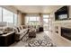 The living room features a fireplace, lots of natural light and is adjacent to the backyard at 10653 E 163Rd Ct, Brighton, CO 80602